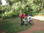 A CHW takes a sick child to the health facility Uganda